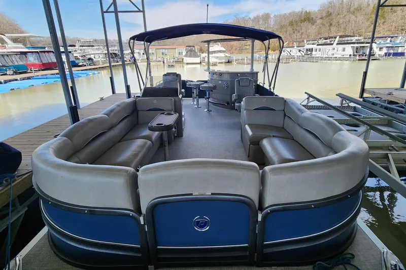 Slide: The Image of 2016 Premier 290 Grand Entertainer pontoon boat docked at marina. - 2