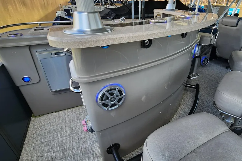 Slide: The Image of 2016 Premier 290 Grand Entertainer boat interior with bar and seating area. - 20