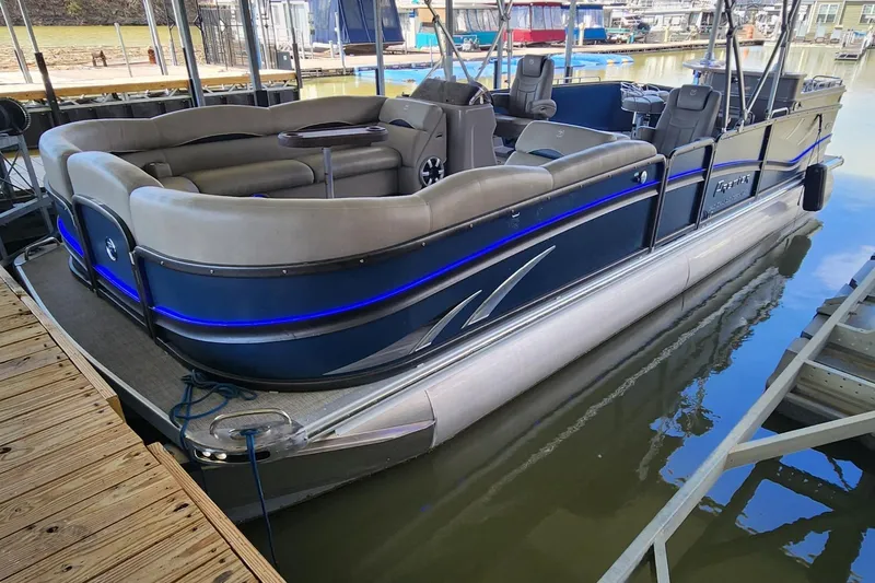 Slide: The Image of 2016 Premier 290 Grand Entertainer pontoon boat docked in marina. - 21