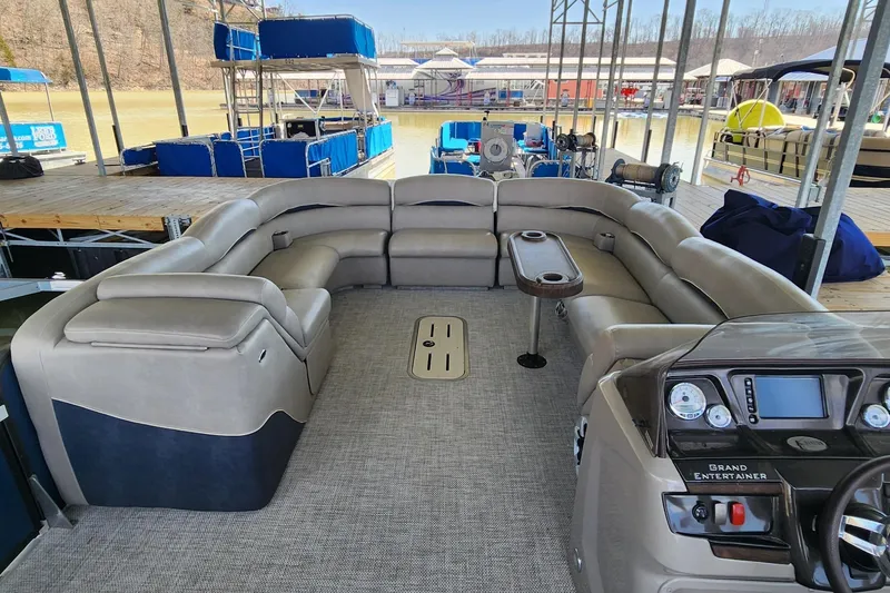 Slide: The Image of 2016 Premier 290 Grand Entertainer pontoon boat with spacious seating and modern dashboard. - 4