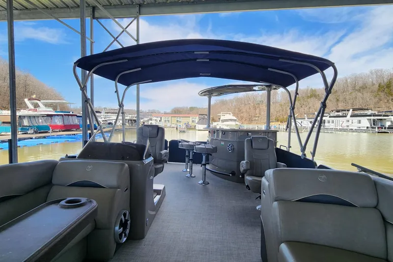 Slide: The Image of 2016 Premier 290 Grand Entertainer pontoon boat docked, featuring spacious seating and canopy. - 6