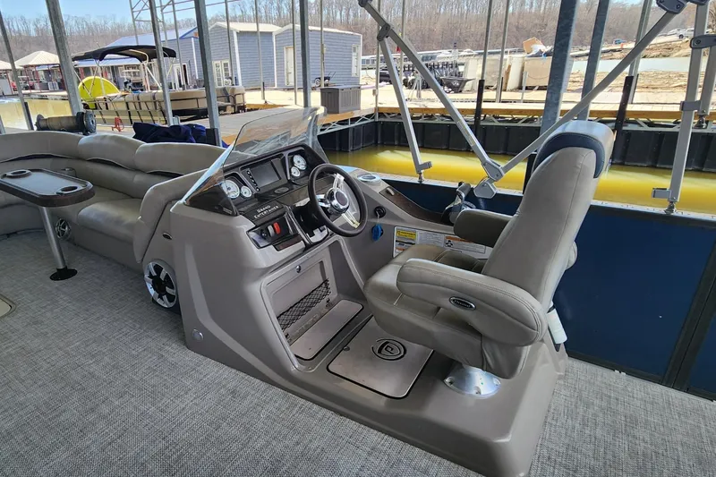 Slide: The Image of 2016 Premier 290 Grand Entertainer boat interior with helm and seating area. - 7