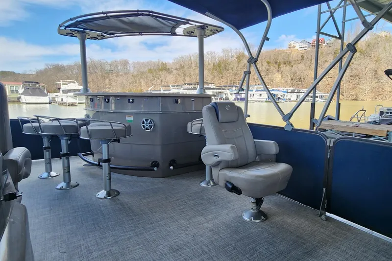 Slide: The Image of 2016 Premier 290 Grand Entertainer boat interior with seating and bar area. - 8
