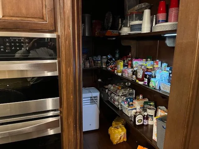 Slide: The Image of Pantry inside 2013 Thoroughbred houseboat, stocked with various food items and kitchen supplies. - 10