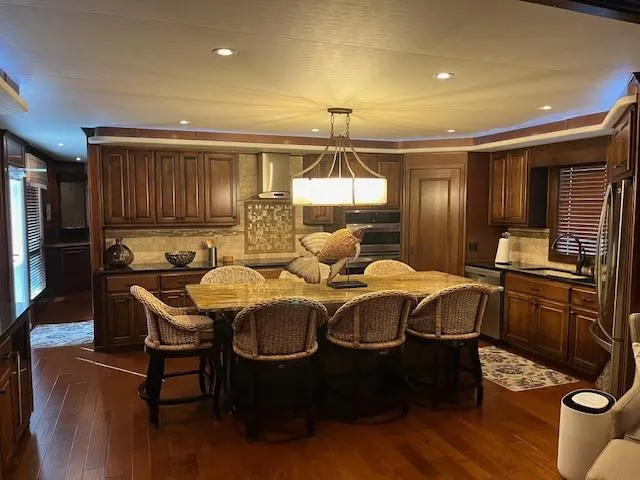 Slide: The Image of Luxurious kitchen interior on 2013 Thoroughbred houseboat with wooden cabinets and island seating. - 14