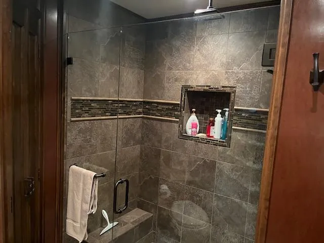 Slide: The Image of Modern houseboat bathroom with tiled shower, glass door, and built-in shelf. Thoroughbred model, 2013. - 20