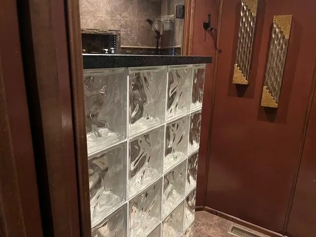 Slide: The Image of Glass block wall in a 2013 Thoroughbred houseboat interior with dark wood accents. - 21