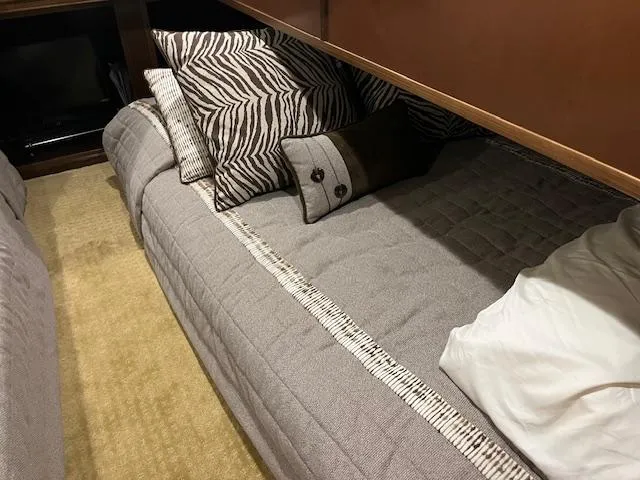 Slide: The Image of Cozy bed with patterned pillows in a 2013 Thoroughbred houseboat interior. - 28