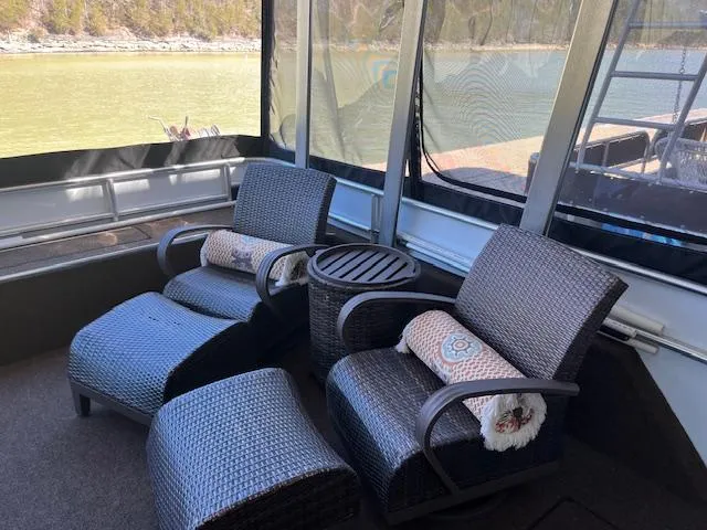 Slide: The Image of Cozy seating area on 2013 Thoroughbred houseboat with wicker chairs and scenic lake view. - 3