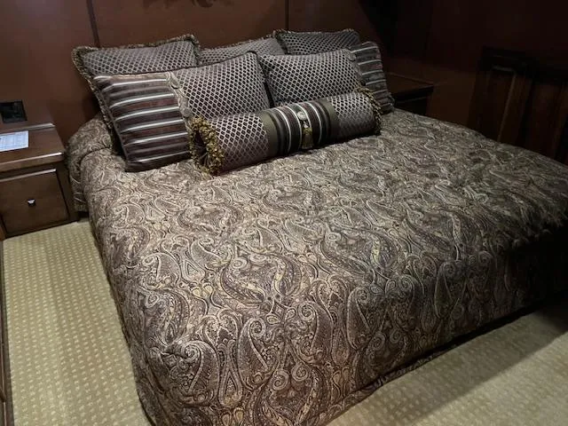 Slide: The Image of Luxurious bed with patterned bedding in a 2013 Thoroughbred houseboat interior. - 31