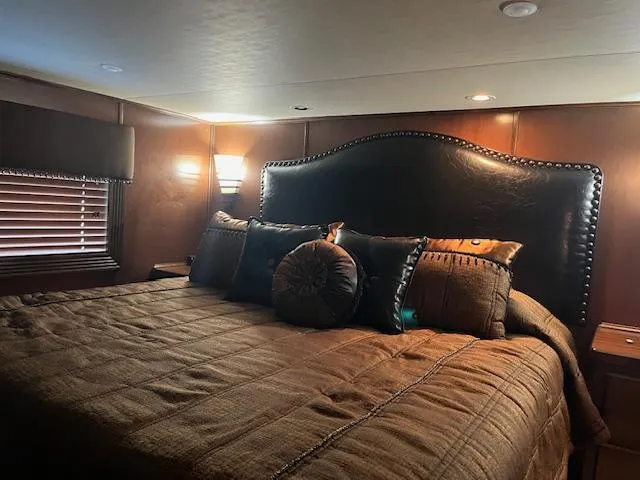 Slide: The Image of Luxurious bedroom interior in a 2013 Thoroughbred houseboat with elegant bedding and ambient lighting. - 35