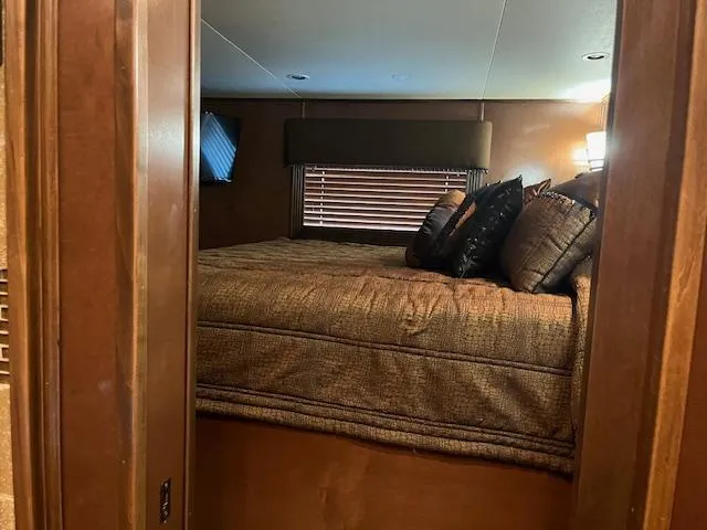 Slide: The Image of Cozy bedroom interior of 2013 Thoroughbred houseboat with plush bedding and ambient lighting. - 36