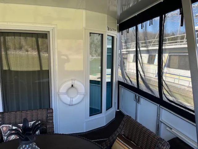 Slide: The Image of 2013 Thoroughbred houseboat interior with wicker furniture and life preserver. - 4