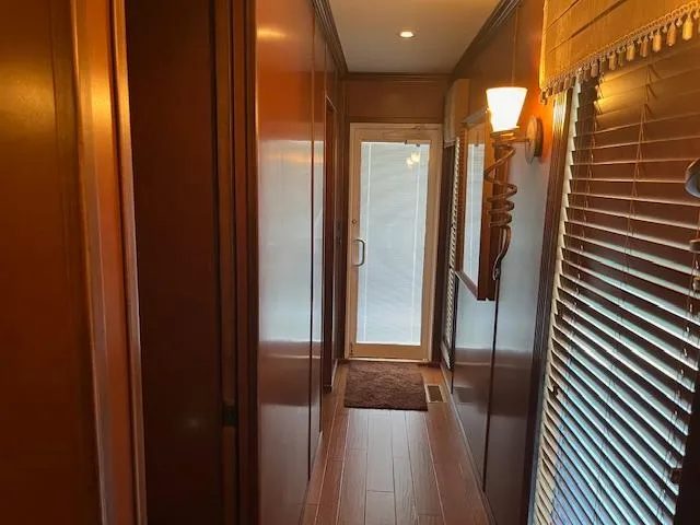 Slide: The Image of Narrow hallway inside 2013 Thoroughbred houseboat with wooden paneling and blinds. - 40