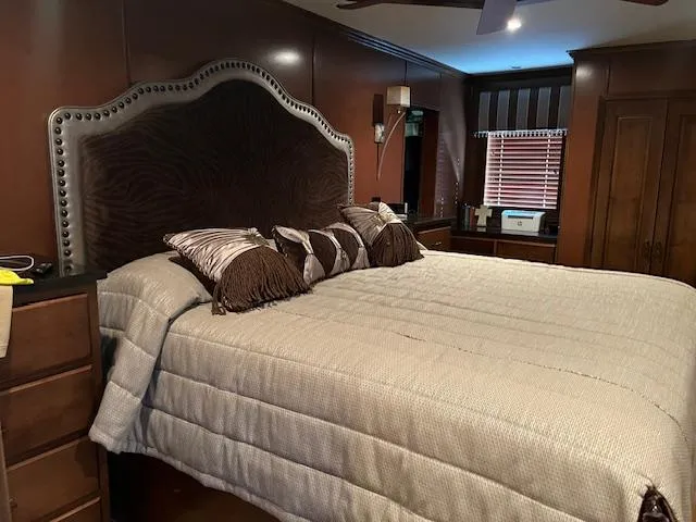Slide: The Image of Luxurious bedroom interior on a 2013 Thoroughbred houseboat with elegant bedding and wooden furnishings. - 45