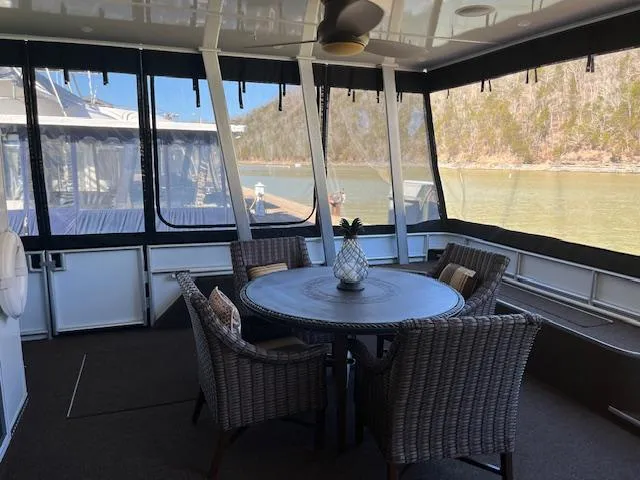 Slide: The Image of Spacious 2013 Thoroughbred houseboat deck with wicker furniture and scenic river view. - 6