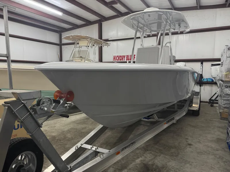 The Image of 2025 Contender 25 Tournament boat on trailer in indoor storage facility. - 1