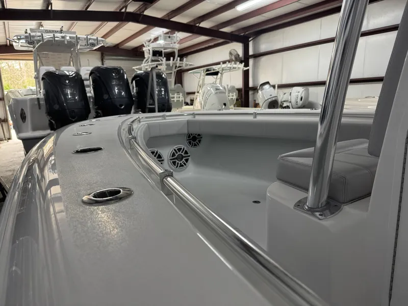 Slide: The Image of 2025 Contender 25 Tournament boat interior in a showroom with multiple engines. - 11