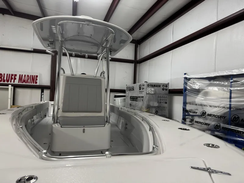 Slide: The Image of 2025 Contender 25 Tournament boat in showroom, featuring center console and T-top. - 12