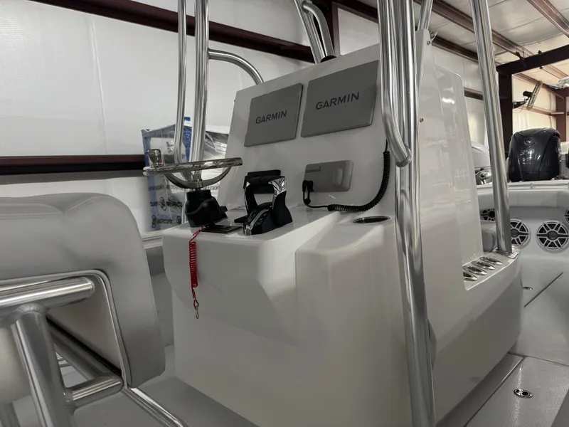 Slide: The Image of 2025 Contender 25 Tournament boat console with Garmin electronics in a storage facility. - 18