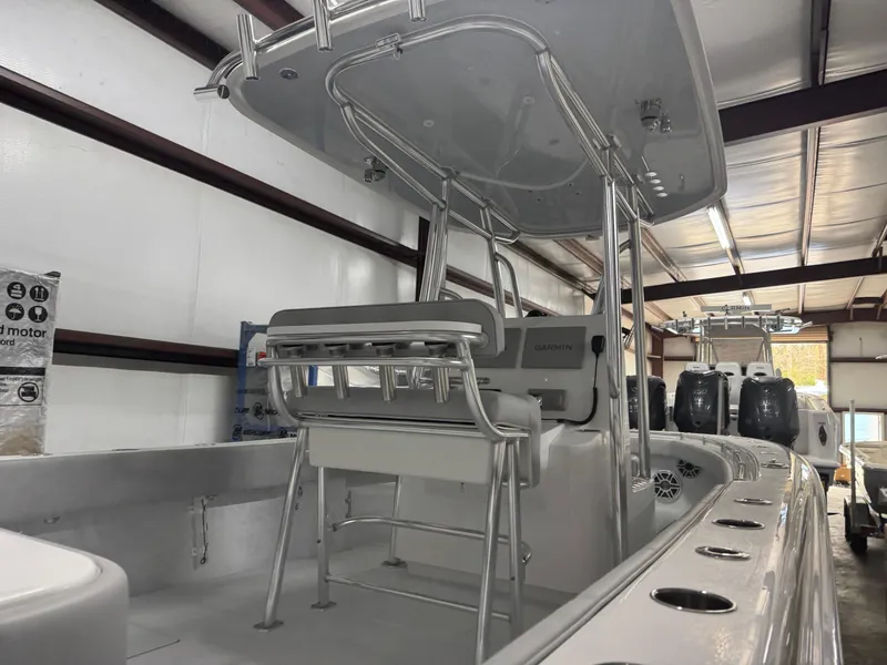 Slide: The Image of 2025 Contender 25 Tournament boat interior with T-top and seating in a storage facility. - 20
