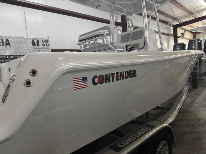 Slide: The Image of 2025 Contender 25 Tournament boat in showroom, featuring sleek design and American flag decal. - 22