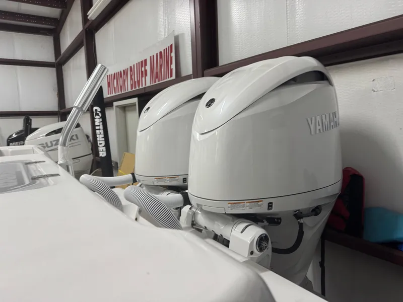 Slide: The Image of 2025 Contender 25 Tournament boat with Yamaha outboard engines in a marine showroom. - 6