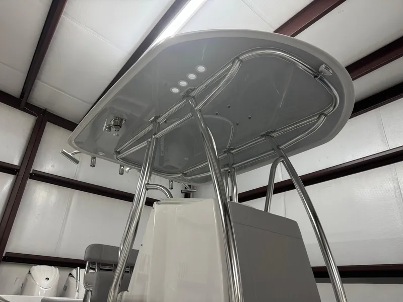 Slide: The Image of 2025 Contender 25 Tournament boat T-top in a storage facility. - 14