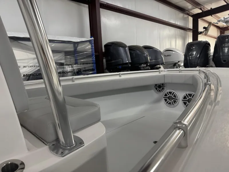 Slide: The Image of 2025 Contender 25 Tournament boat interior with stainless steel railings and speakers in a showroom. - 15