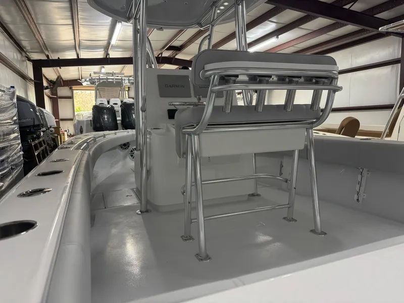 Slide: The Image of 2025 Contender 25 Tournament boat interior with seating and console in a warehouse. - 4