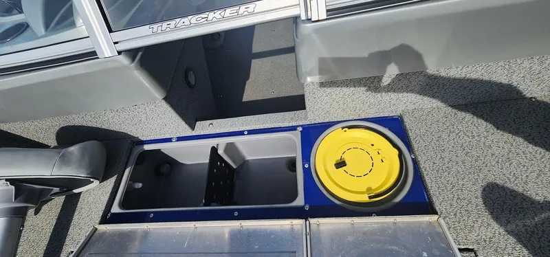 Slide: The Image of 2016 Tracker Pro Guide V-16 WT boat interior with storage compartments and seating. - 10