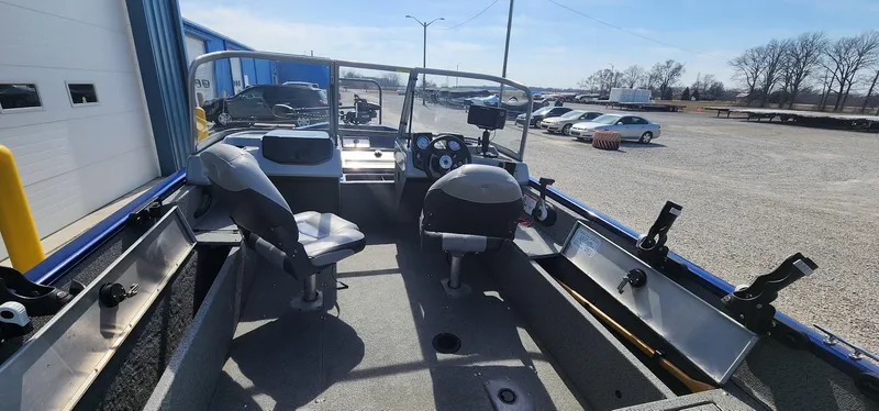Slide: The Image of 2016 Tracker Pro Guide V-16 WT boat interior with seating and steering console. - 5