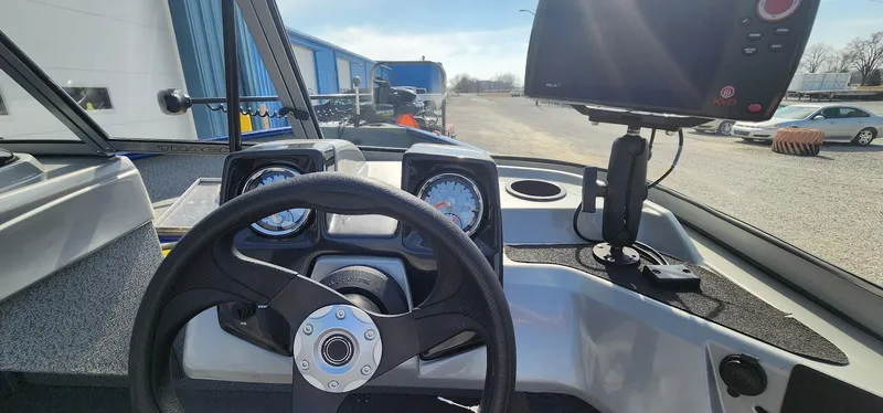 Slide: The Image of 2016 Tracker Pro Guide V-16 WT boat dashboard with steering wheel and gauges. - 6