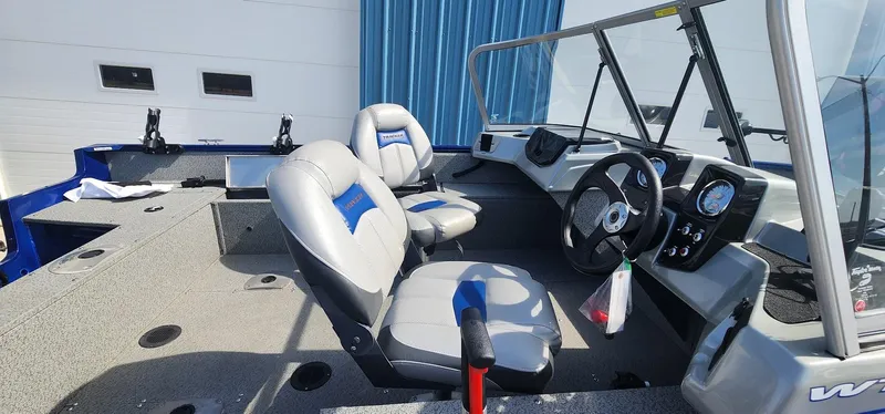 Slide: The Image of 2016 Tracker Pro Guide V-16 WT boat interior with steering wheel and seating. - 7