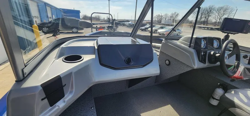 Slide: The Image of 2016 Tracker Pro Guide V-16 WT boat interior with steering wheel and dashboard controls. - 9