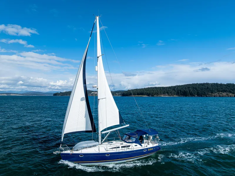 Slide: The Image of 2001 Jeanneau Sun Odyssey 40 sailing on open water under clear blue skies. - 10