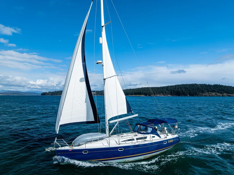 Slide: The Image of 2001 Jeanneau Sun Odyssey 40 sailing on open water under clear blue skies. - 11