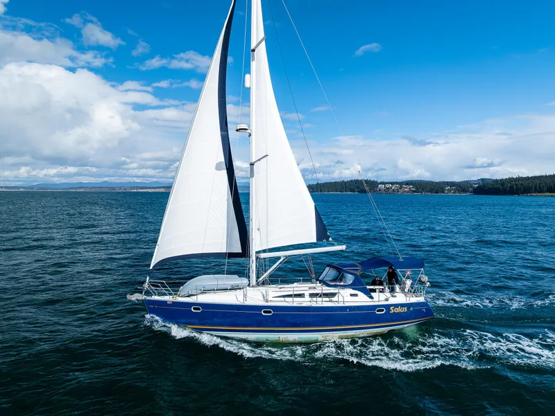 Slide: The Image of 2001 Jeanneau Sun Odyssey 40 sailing on open water under clear blue skies. - 12