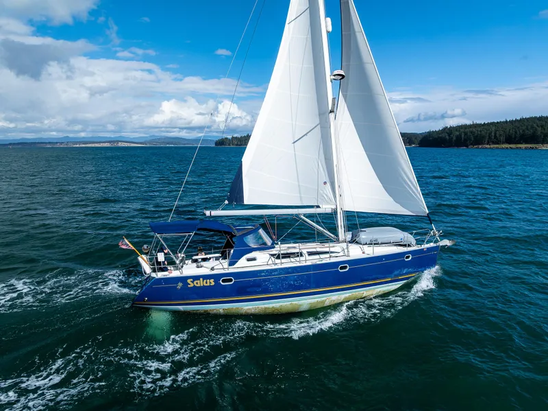 Slide: The Image of 2001 Jeanneau Sun Odyssey 40 sailing on open water under clear blue skies. - 16