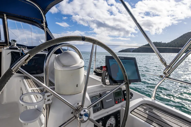 Slide: The Image of Cockpit view of 2001 Jeanneau Sun Odyssey 40 sailboat with ocean and island backdrop. - 20