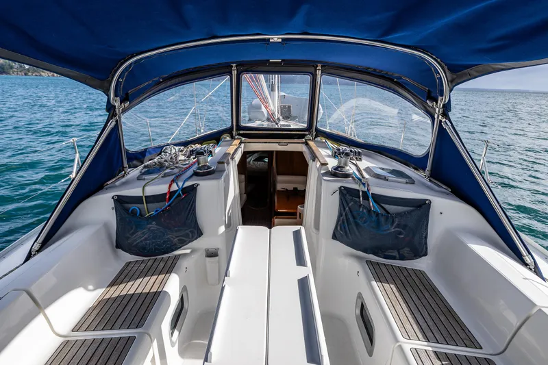 Slide: The Image of Cockpit of 2001 Jeanneau Sun Odyssey 40 sailboat with blue canopy and teak seating. - 23