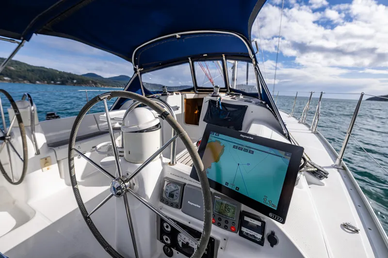 Slide: The Image of Cockpit of 2001 Jeanneau Sun Odyssey 40 sailboat with navigation equipment and steering wheel. - 24