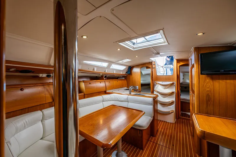 Slide: The Image of Interior of 2001 Jeanneau Sun Odyssey 40 yacht, featuring elegant wood finish and comfortable seating. - 32