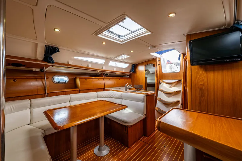 Slide: The Image of Interior of 2001 Jeanneau Sun Odyssey 40 yacht with wood finish and seating area. - 33