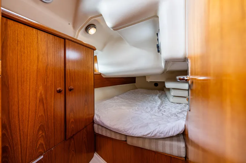 Slide: The Image of Cozy cabin interior of 2001 Jeanneau Sun Odyssey 40 sailboat with wooden cabinetry. - 35