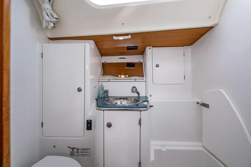 Slide: The Image of 2001 Jeanneau Sun Odyssey 40 yacht bathroom with sink, cabinets, and white interior. - 37