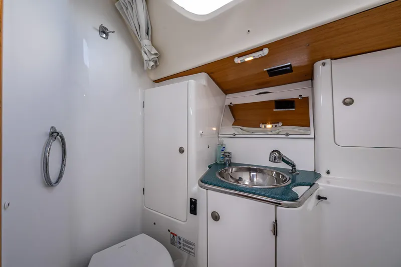 Slide: The Image of 2001 Jeanneau Sun Odyssey 40 yacht bathroom with sink, toilet, and storage cabinets. - 38