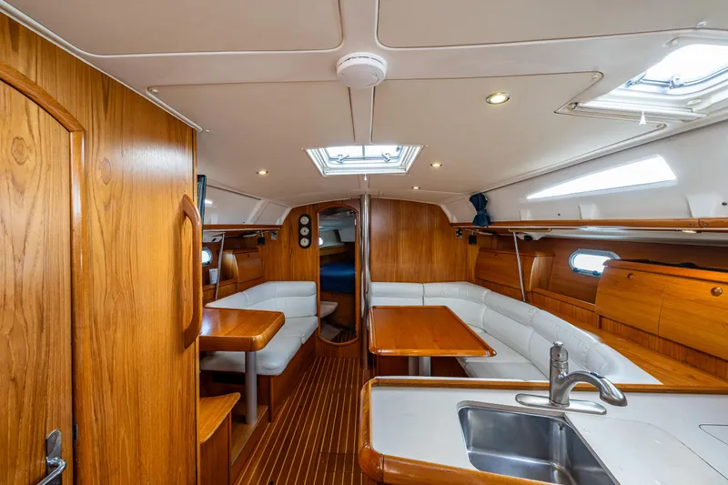 Slide: The Image of Interior of 2001 Jeanneau Sun Odyssey 40 sailboat with wood finish and seating area. - 39