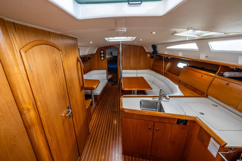 Slide: The Image of Interior of 2001 Jeanneau Sun Odyssey 40 sailboat with wooden cabinetry and seating area. - 40