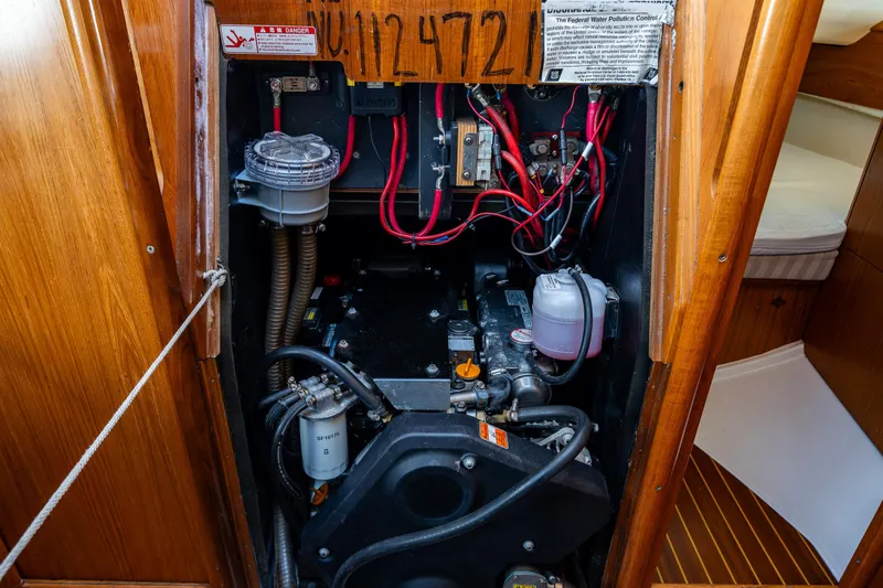 Slide: The Image of Engine compartment of 2001 Jeanneau Sun Odyssey 40 sailboat, showcasing wiring and components. - 42